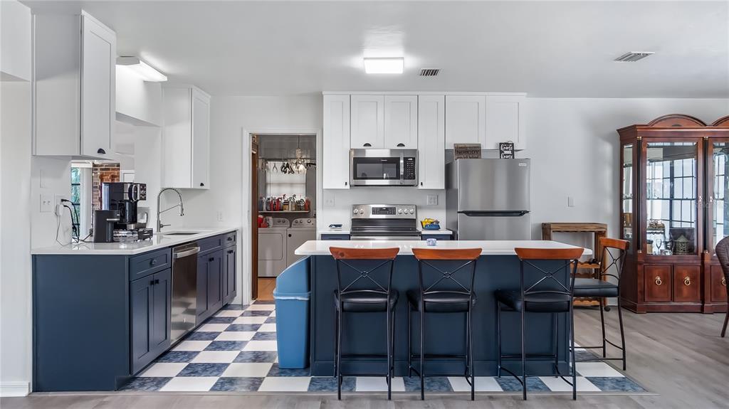 16317 Andrews Circle Cedar Key, FL 32625 - Photo 9 of 53 a kitchen with granite countertop lots of wooden cabinets a sink and appliances