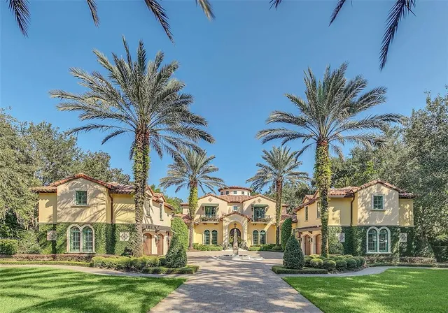 a view of a white house with a yard and sitting area