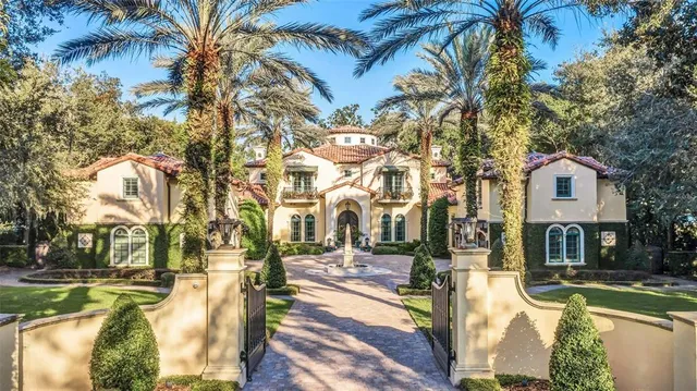 a living room with furniture a fireplace and large windows