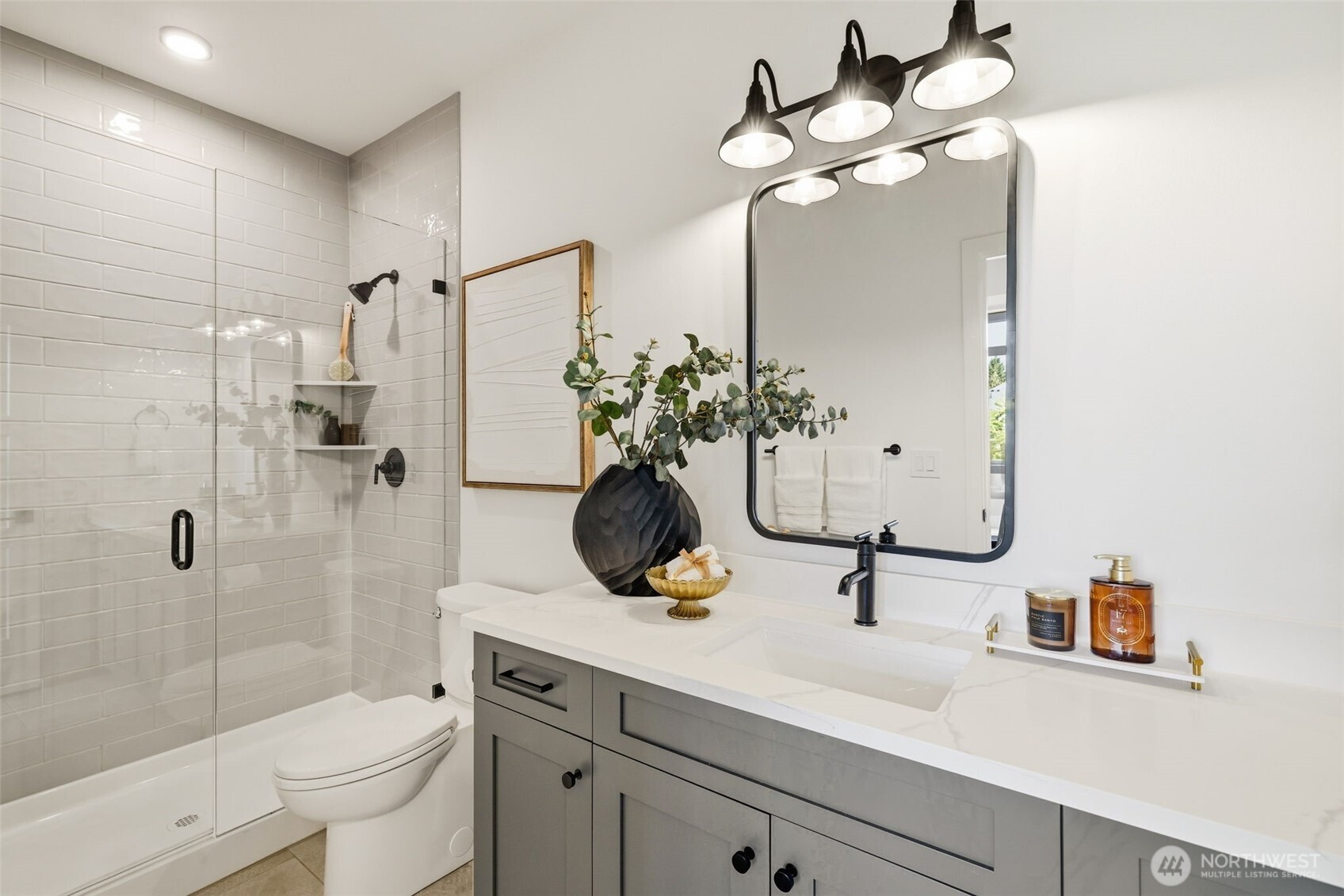 2944 215th Place Southwest Brier, WA 98036 - Photo 23 of 40 a bathroom with a sink a toilet and shower