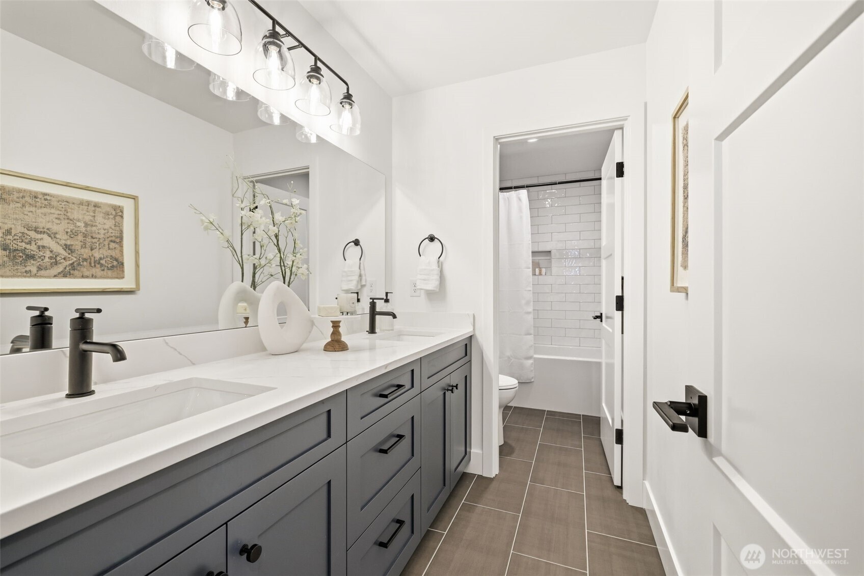 2944 215th Place Southwest Brier, WA 98036 - Photo 27 of 40 a spacious bathroom with a double vanity sink a mirror a shower and a bathtub