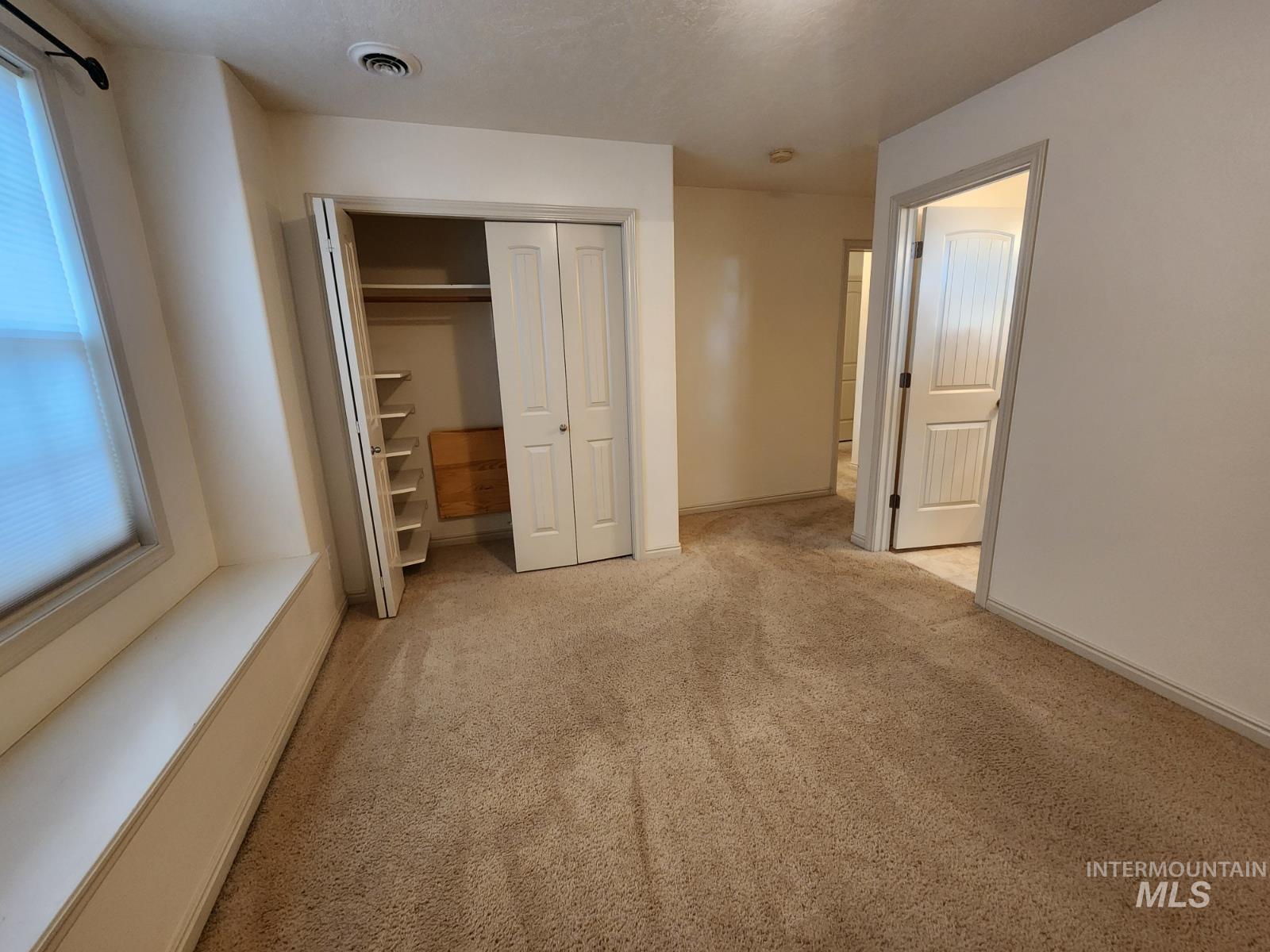 1000 North Rodeo Street Parma, ID 83660 - Photo 16 of 35 Unfurnished bedroom with light colored carpet and a closet