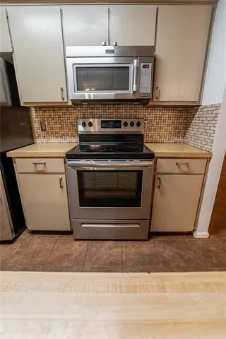 a stove top oven sitting inside of a kitchen