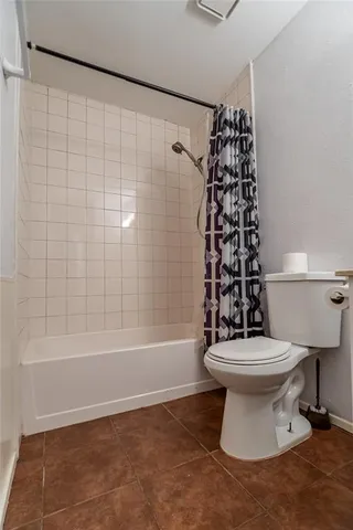 a bathroom with a toilet a sink and bathtub