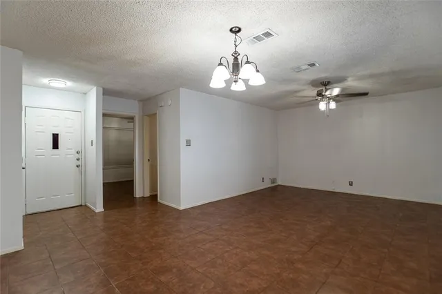 a view of a chandelier in big room and chandelier