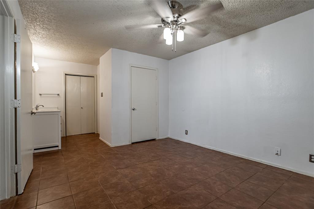 3327 Fallmeadow Street Denton, TX 76207 - Photo 23 of 31 an empty room with a ceiling fan and a bathroom