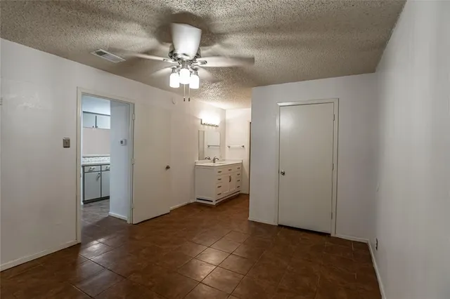 a view of a big room with closet and a chandelier fan