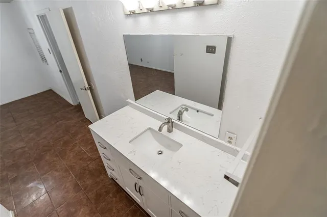 a bathroom with a sink and mirror