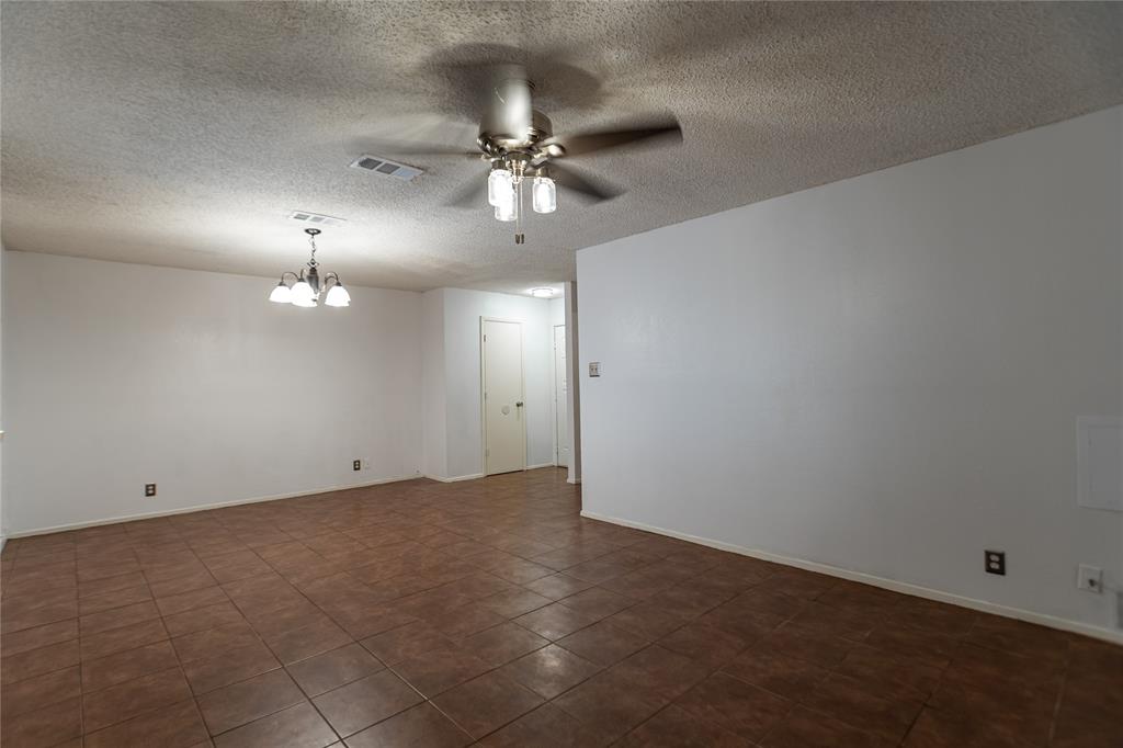3327 Fallmeadow Street Denton, TX 76207 - Photo 3 of 31 an empty room with a fan & a chandelier fan