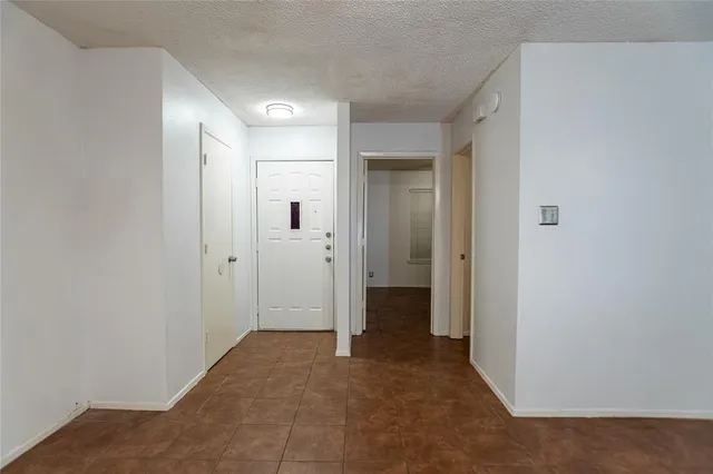 a view of a hallway with closet and bathroom