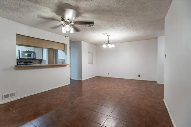 a view of a livingroom with a ceiling fan and chandelier fan