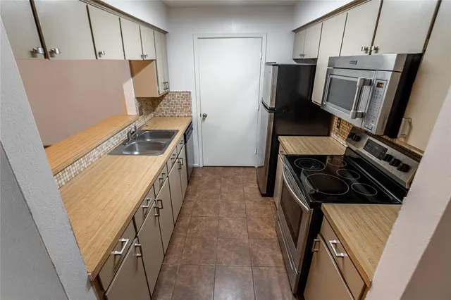 a kitchen with a stove and a refrigerator