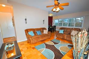 615 Palmer Road, Unit 101 Yonkers, NY 10701 - Photo 1 of 1 a living room with patio area furniture and a chandelier