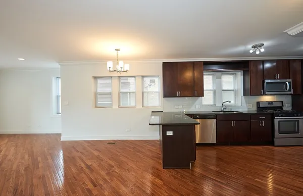 a kitchen with granite countertop a stove and a sink