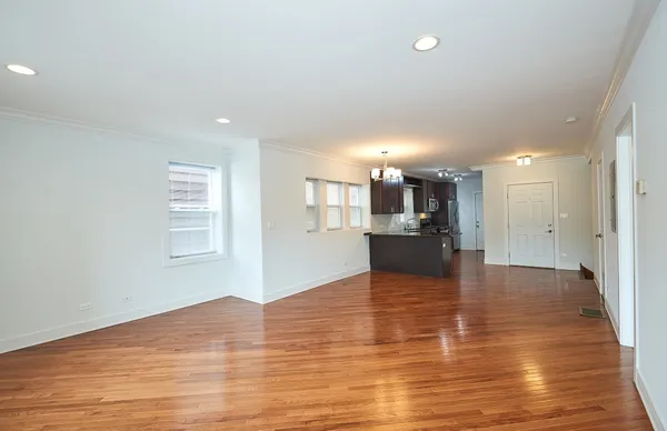 a view of kitchen with kitchen island wooden floor and window