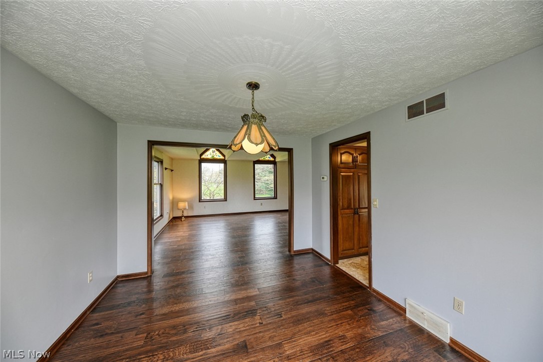 915 Sandy Lake Road Kent, OH 44240 - Photo 21 of 35 Here, looking towards the front of the home from the dining room. The living room continues with the same beautiful floor. Note the stained glass accents of the living room palladiums