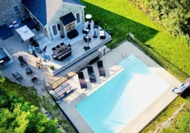 a backyard of a house with table and chairs