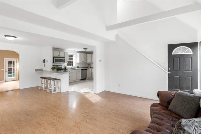 a living room with furniture and kitchen view
