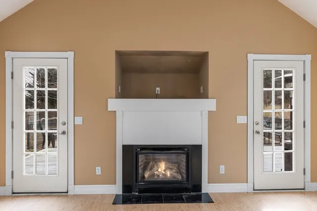 a living room with a fireplace and a flat screen tv