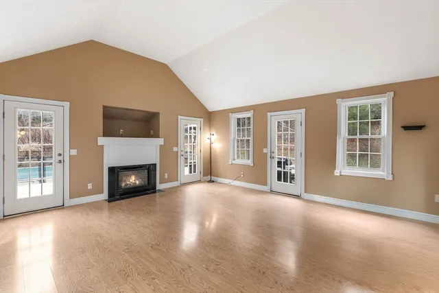 a view of an empty room with a fireplace and a window