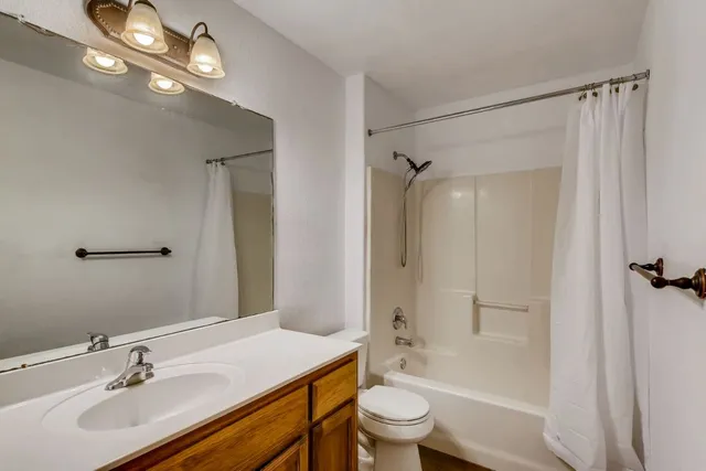 a bathroom with a sink toilet a shower and a mirror
