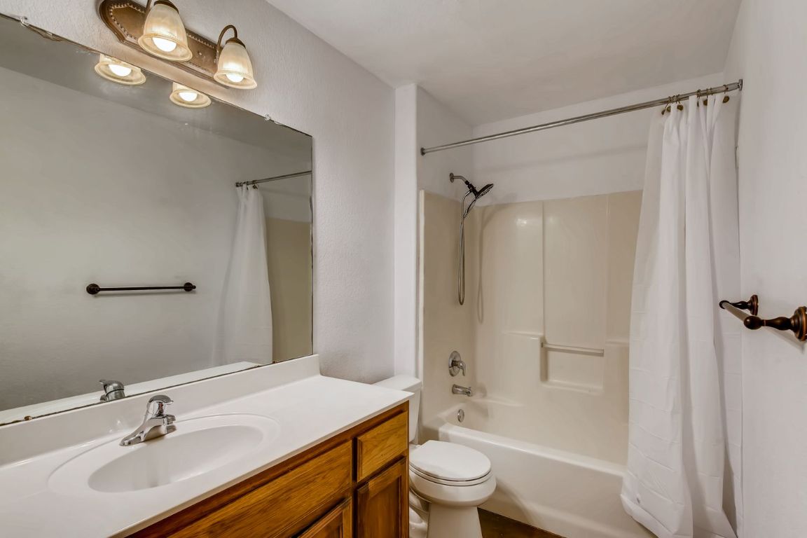 300 Venture Boulevard South Point Venture, TX 78645 - Photo 12 of 14 a bathroom with a sink toilet a shower and a mirror