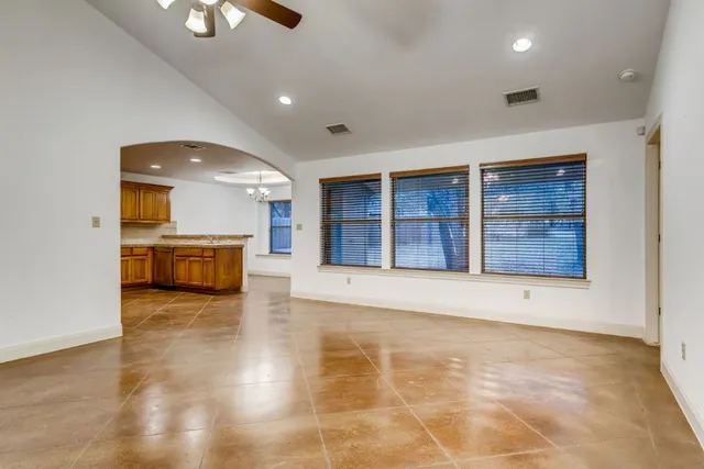 a view of an empty room with cabinet and wooden floor