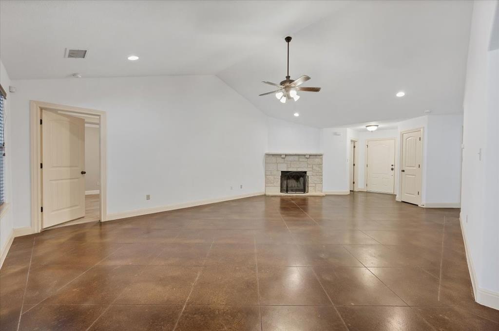 300 Venture Boulevard South Point Venture, TX 78645 - Photo 8 of 14 a view of an empty room with wooden floor fireplace and a window