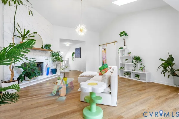 a living room with furniture and a potted plant