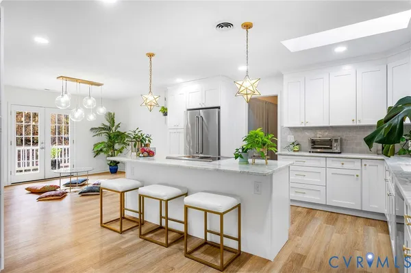 a kitchen with a table chairs refrigerator and microwave