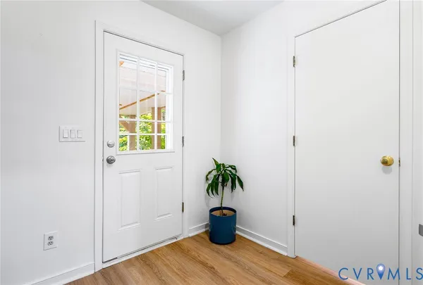 a view of an entryway with wooden floor