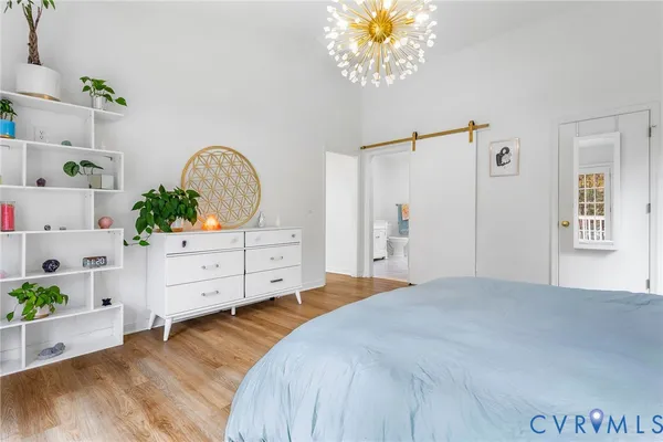 a bedroom with a bed dresser and a window