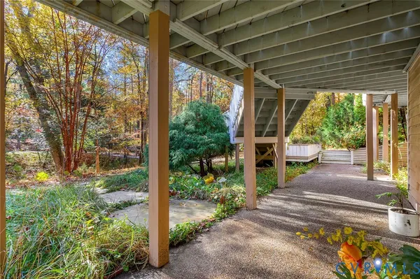 a view of a porch with furniture and garden