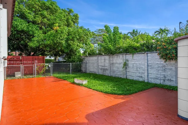 a view of a house with a yard and potted plants
