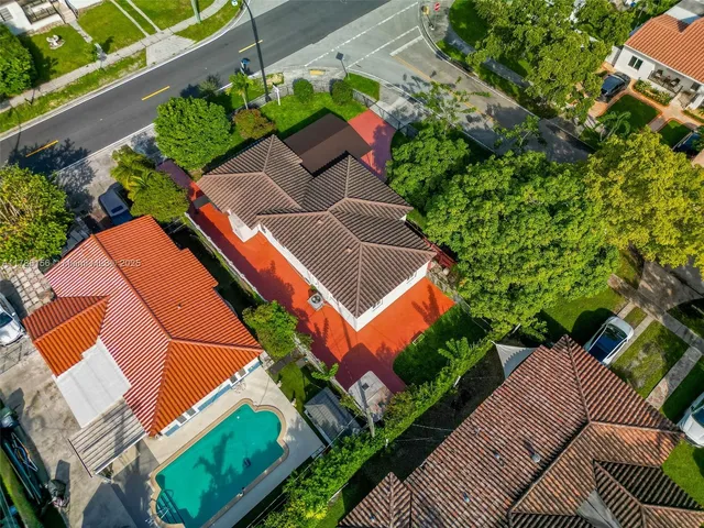 an aerial view of residential houses with outdoor space and street view