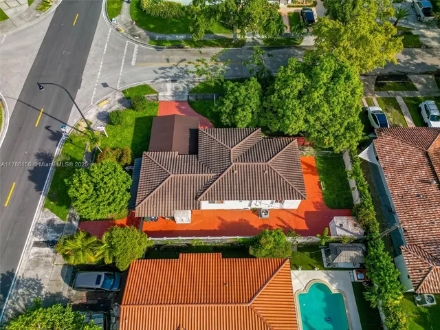 an aerial view of residential houses with outdoor space and street view
