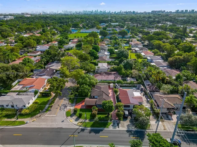 an aerial view of residential houses with outdoor space and street view