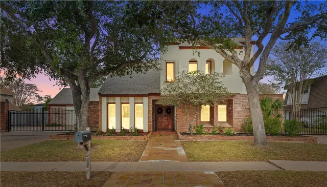 a front view of a house with a garden