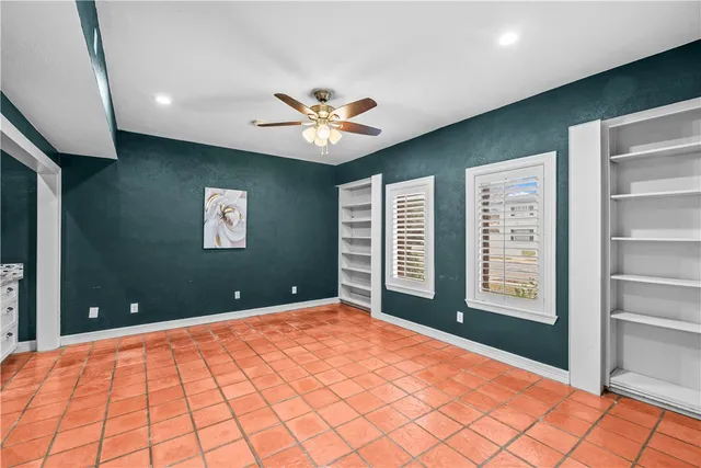 a view of an empty room with a window and closet