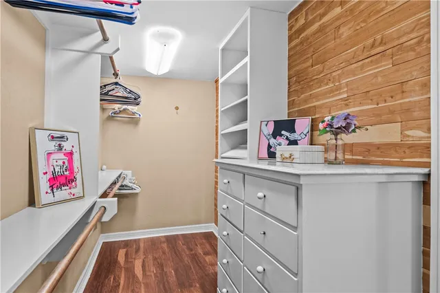 a kitchen with cabinets and a wooden floor