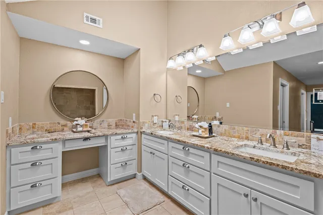 a bathroom with a double vanity sink and a mirror