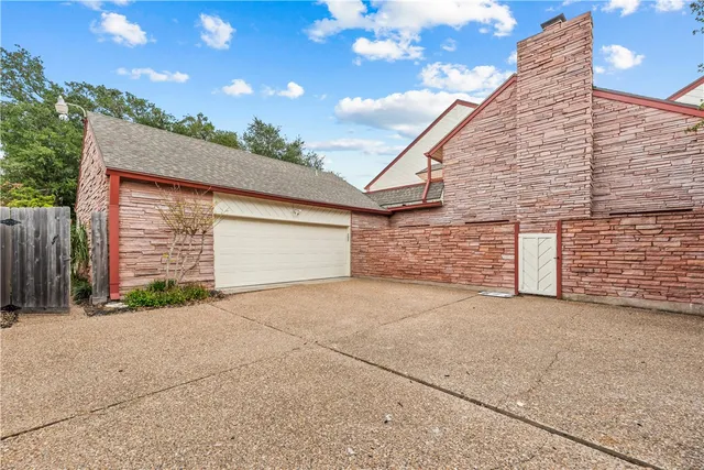 a view of backyard of house and garage