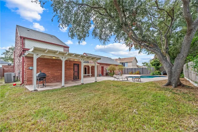 a view of a house with backyard porch and sitting area