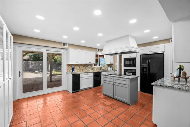 a kitchen with a refrigerator and a stove top oven
