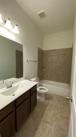 a bathroom with a sink a toilet and bathtub