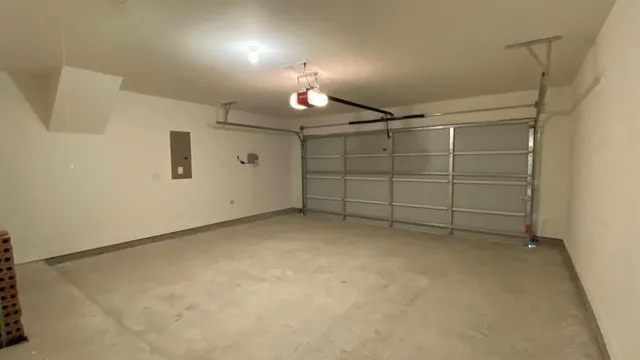 an empty room with a ceiling fan and window