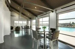 a dining room with furniture and a floor to ceiling window