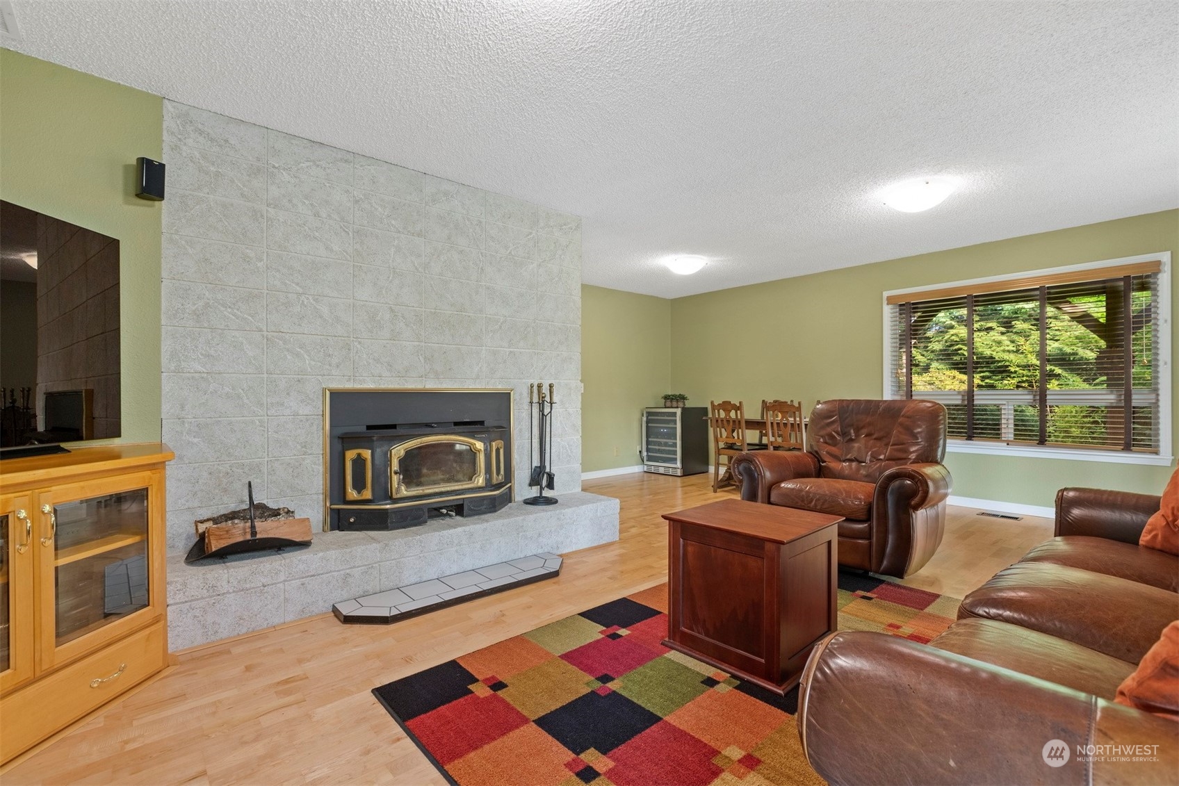 555 East Hemmi Road Lynden, WA 98264 - Photo 23 of 40 a living room with furniture a flat screen tv and a fireplace