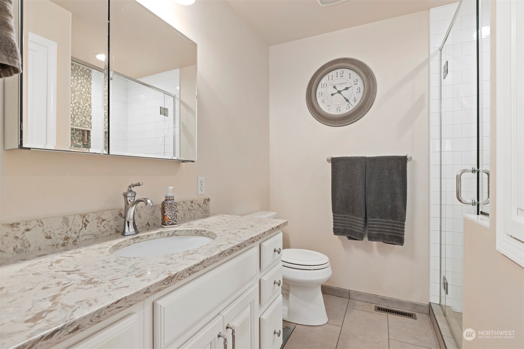 555 East Hemmi Road Lynden, WA 98264 - Photo 8 of 40 a bathroom with a granite countertop toilet sink and mirror