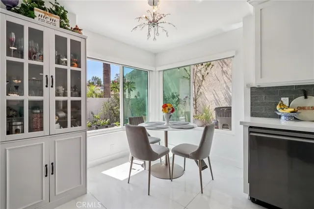 a dining room with furniture a chandelier and wooden floor